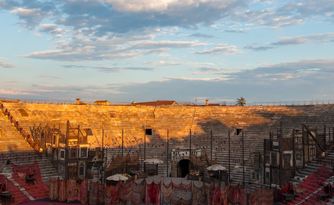 Opera stage set inside the Arena di Verona at sunset, during the summer opera season